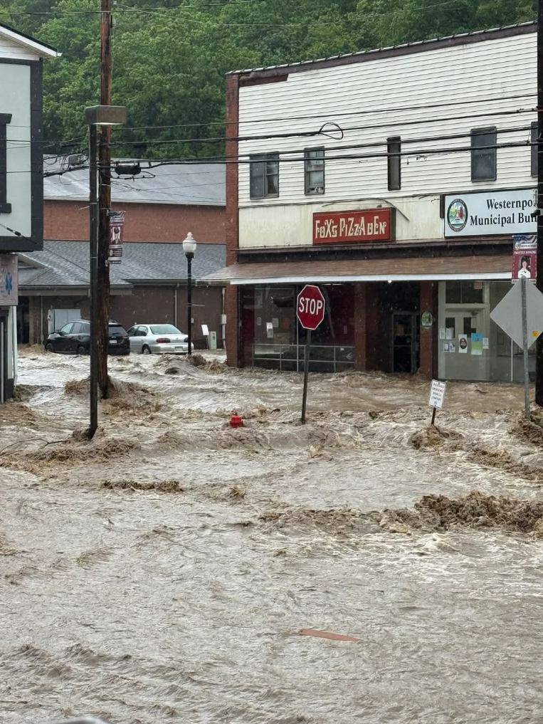 Severe flooding on Maryland road near a municipal building.